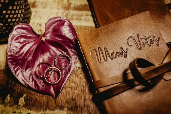 Eine Nahaufnahme Von Ringen Auf Einem Blumenblatt Neben Einem Notizbuch — Stockfoto