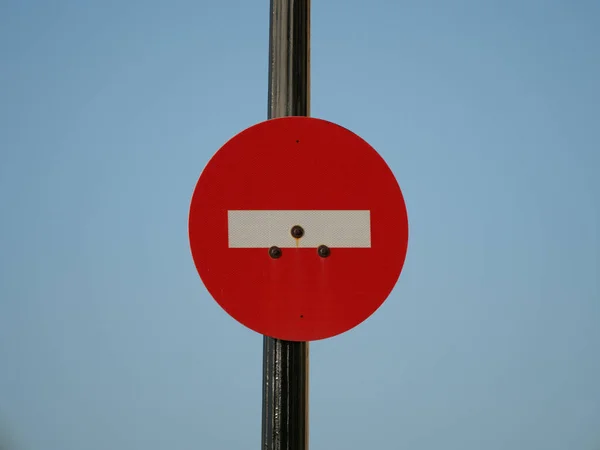A red \'do not enter\' sign against blue background