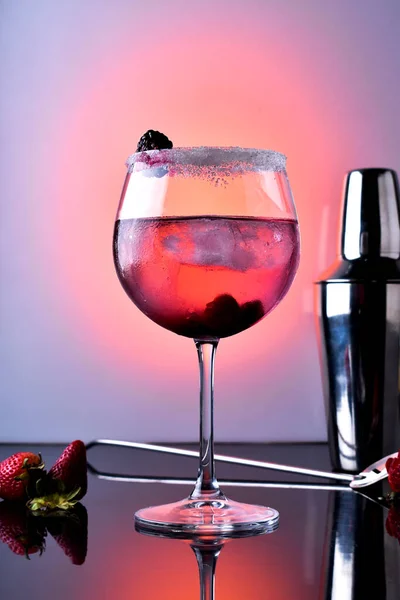 一个用黑莓 覆盆子 瓶子和勺子做的鸡尾酒的垂直镜头 — 图库照片