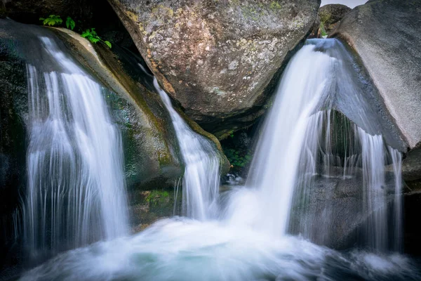 Uma Cachoeira Com Longa Exposição Cercada Por Rochas Uma Floresta — Fotografia de Stock