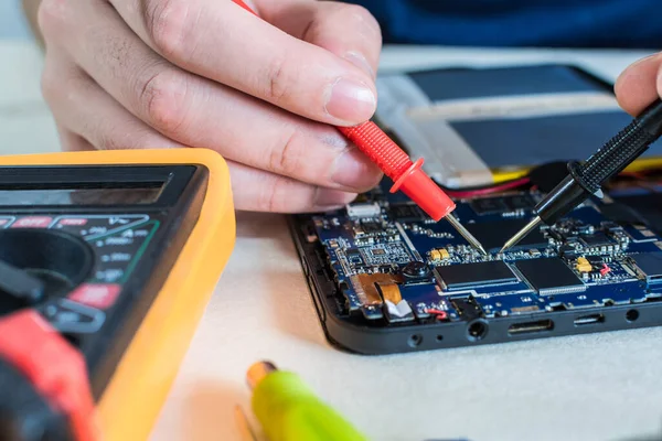 A close up shot of smart phone and tablet repair in a technology lab.