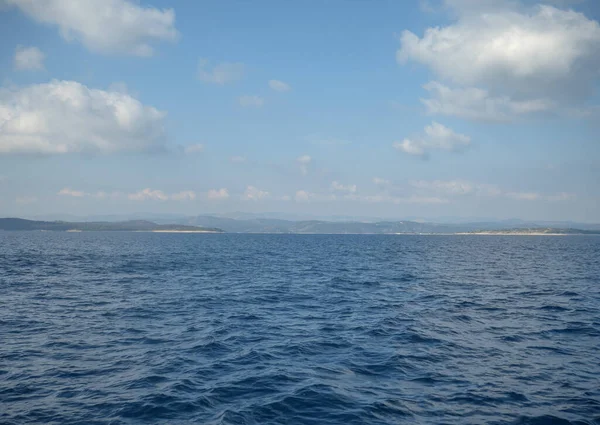 Een Kalme Oceaan Met Glinsterend Water Bergen Aan Horizon Onder — Stockfoto