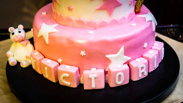 テーブルの上のトレイに星と名前を持つピンクの誕生日ケーキのクローズアップ — ストック写真