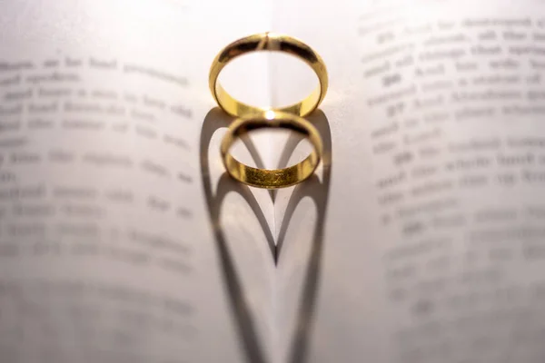 Closeup Two Golden Engagement Rings Forming Shadow Heart Open Holy — Stock Photo, Image