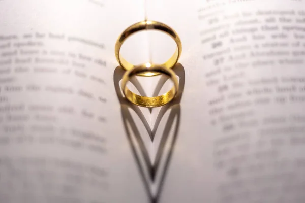 Closeup Two Golden Engagement Rings Forming Shadow Heart Open Holy — Stock Photo, Image