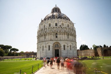 Tourists around the Baptistery in Pisa clipart
