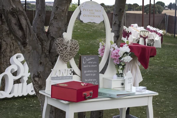 A closeup of a vanity table on a wedding reception displayed outdoors