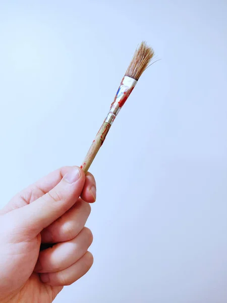 Vertical Shot Hand Holding Used Paintbrush Isolated Light Blue Background — Stock Photo, Image