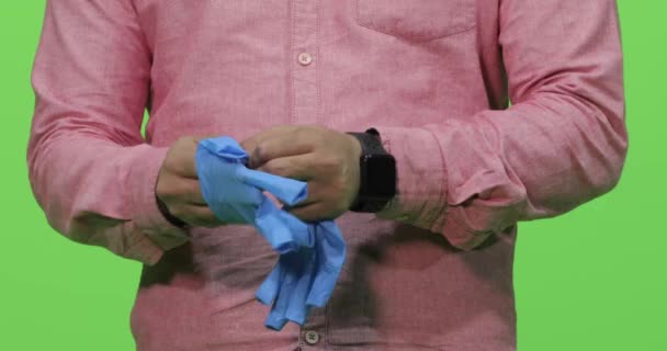 Male Hands Wearing Blue Color Medical Gloves Green Background — Stock Video