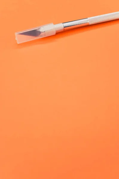 Vertical Shot Metallic Scalpel Cap Isolated Orange Background — Stock Photo, Image
