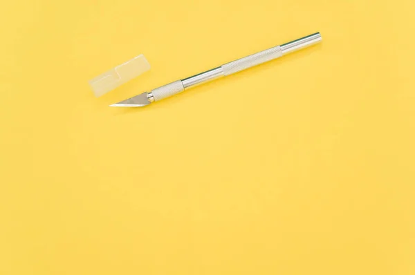 High Angle Shot Metallic Scalpel Cap Isolated Yellow Background — Stock Photo, Image