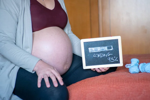 Closeup Pregnant Woman Sitting Bed Holding Small Blackboard Loading Written — Stock Photo, Image