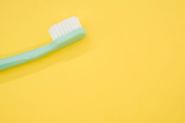 Turquoise Toothbrush Yellow Surface Copy Space — Stock Photo, Image