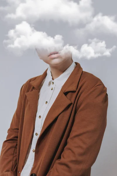 A serene female with her head in the clouds, the concept of  being unrealistic or out of touch with the everyday world