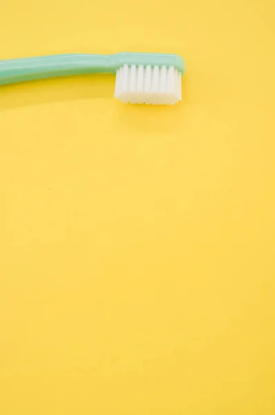 Vertical Shot Turquoise Toothbrush Yellow Surface Copy Space — Stock Photo, Image