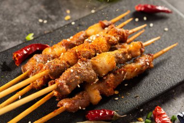 A selective focus shot of delicious meat on wooden skewers seasoned with various spices clipart