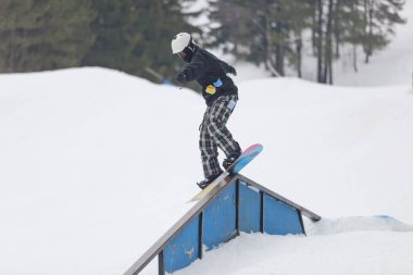 A snowboarder on a ramp at the Wisp Ski Resort in Deep Creek Lake Maryland clipart
