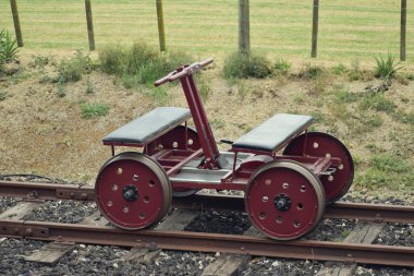 View of empty handcar on railroad tracks at Glenbrook Vintage Railway clipart