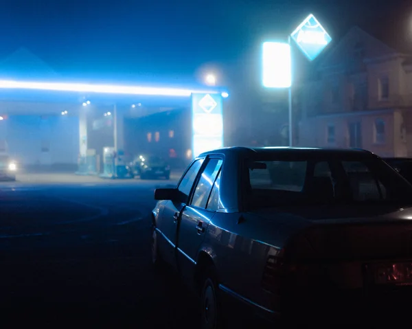 A car in the street at night with street lights