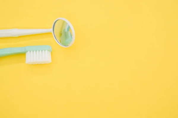 Closeup Toothbrush Dental Mouth Mirror Isolated Yellow Background Copy Spac — Stock Photo, Image