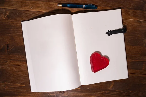 Wysokie Ujęcie Małego Walentynkowego Notatnika Długopisem Drewnianym Stole — Zdjęcie stockowe