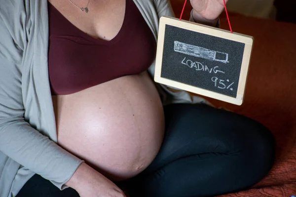Closeup Pregnant Woman Sitting Bed Holding Small Blackboard Loading Written — Stock Photo, Image