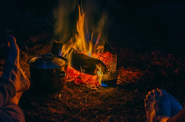 Pernas Dos Amigos Perto Fogueira Noite Enquanto Faz Comida Uma — Fotografia de Stock