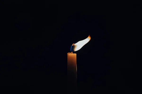 Clsoeup Shot Light Candle Its Flame Deviated Wind Isolated Black — Stock fotografie