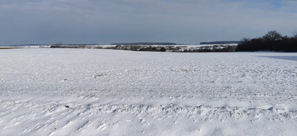 Een Leeg Veld Bedekt Met Sneeuw Achtergrond Van Bewolkte Hemel — Stockfoto