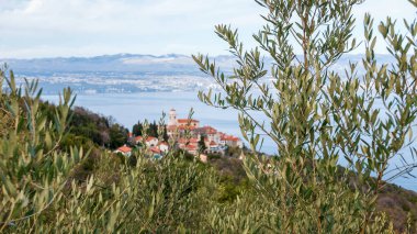 Town of top of hill overlooking the sea. Bay, Croatia, Kvarner, Rijeka, Moscenice, view, selective focus, focus on foregreound. clipart
