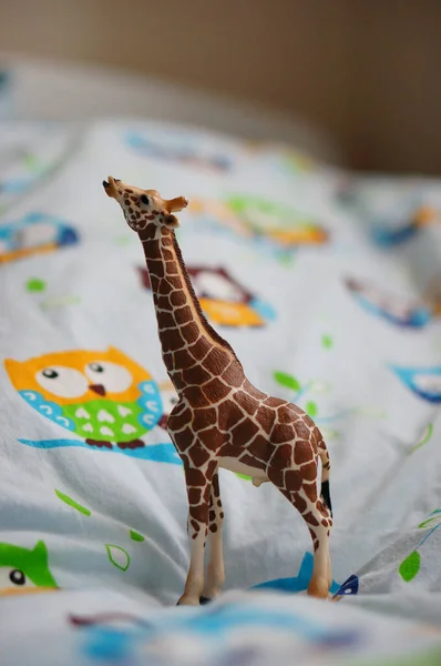 Poznan Poland Jul 2017 Schleich Toy Giraffe Figurine Bed Sheet — Stock Photo, Image