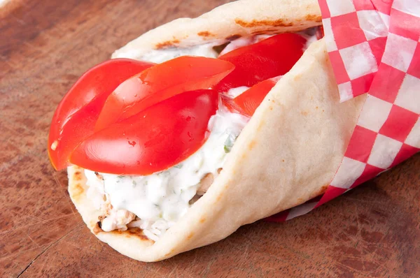 chicken pita wrap with tomato, rice and tzatziki