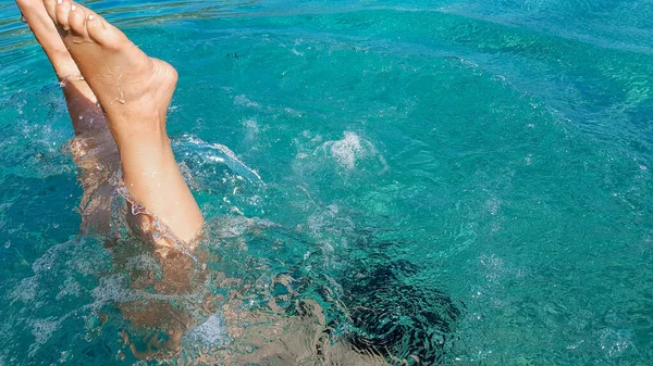 クリスタルクリアターコイズブルーの水で若い女性の水泳やダイビング 晴れた日 楽しみ — ストック写真