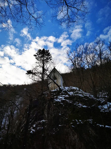 在蓝云的天空下 一座靠近山丘的房子的垂直照片 — 图库照片
