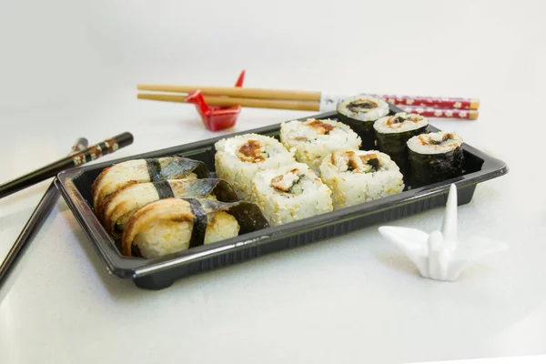Close Rolos Sushi Enguia Com Pauzinhos Recipiente Preto — Fotografia de Stock