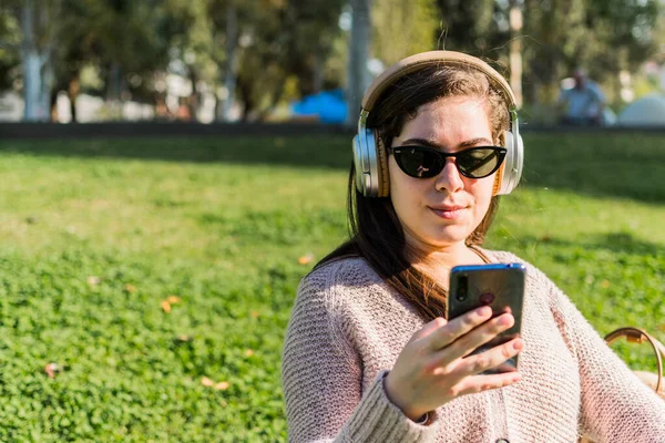 Uma Jovem Caucasiana Ouvindo Música Com Fones Ouvido Enquanto Mensagens — Fotografia de Stock