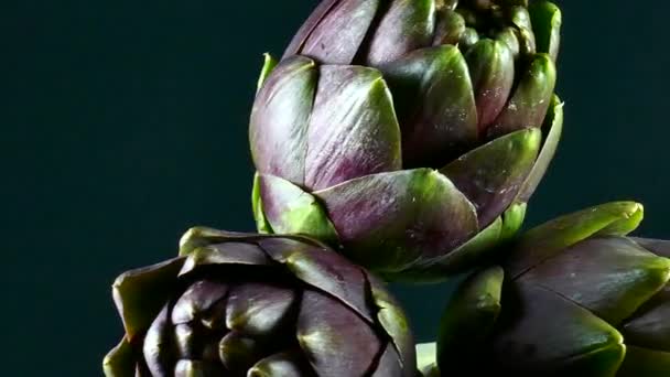 Three Rotating Fresh Artichokes Shot — Stock Video