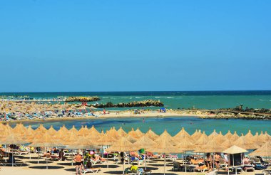 MANGALIA, ROMANIA - Aug 28, 2018: the beach of Mangalia Saturn resort Constanta county - Romania clipart