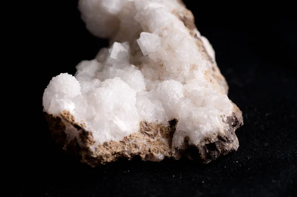 white chabazite crystal mineral sample on granite