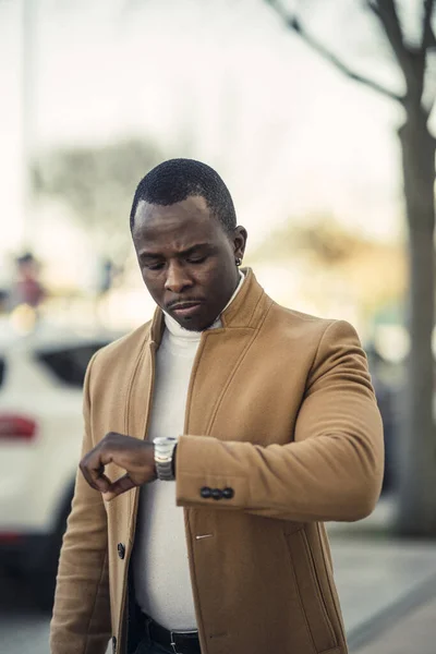 Young Fashionable Black Man Wearing Brown Coat Checking Time His — Stock Photo, Image