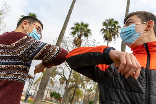 Stock Photo Two Young Friends Wearing Face Mask Greeting Each — Stock Photo, Image