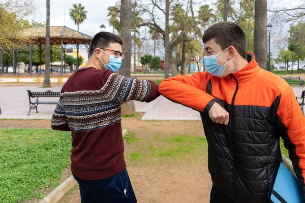 Stock Photo Two Young Friends Wearing Face Mask Greeting Each — Stock Photo, Image