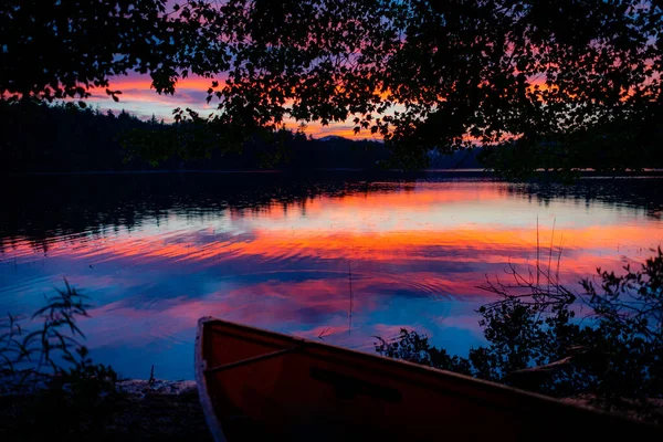 The sun sets after a rains storm over Turtle Pond, in the St. Regis area of the Adirondacks in New York State, next to Saranac Lake.