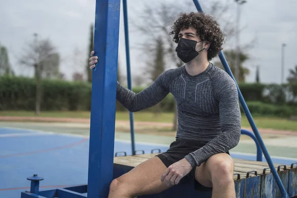 Young Attractive European Guy Sitting Equipment Wearing Sanitary Mask Sportswear — Stock Photo, Image