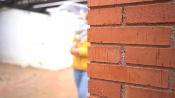 Slow Motion Blurred Spanish Woman Passing Brick Wall — Stok video