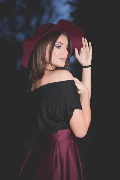 Vertical Shot Young Female Burgundy Skirt Hat Posing Dark Background — Stock fotografie