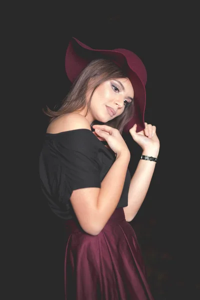 Vertical Shot Young Female Burgundy Skirt Hat Posing Dark Background — Stok fotoğraf