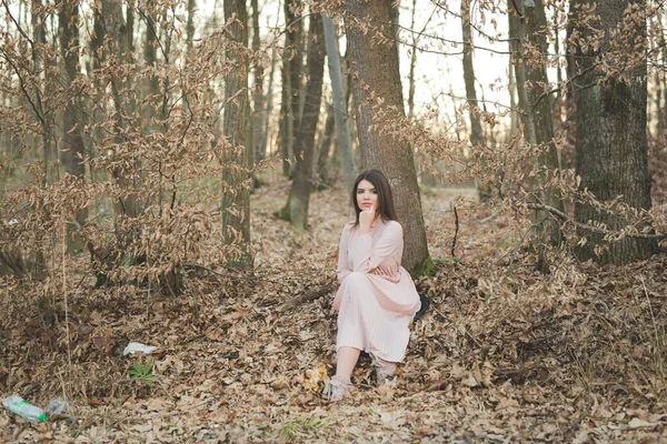 Young Caucasian Woman Elegant Pink Dress Sitting Ground Forest — Zdjęcie stockowe