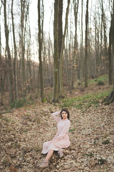 Young Caucasian Female Delicate Pink Dress Sitting Fallen Dry Trees — Zdjęcie stockowe