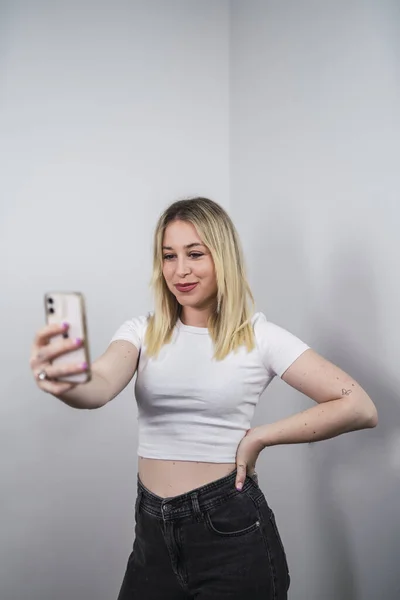 Young Caucasian Female Spain Taking Selfie Phone White Wall — Foto de Stock